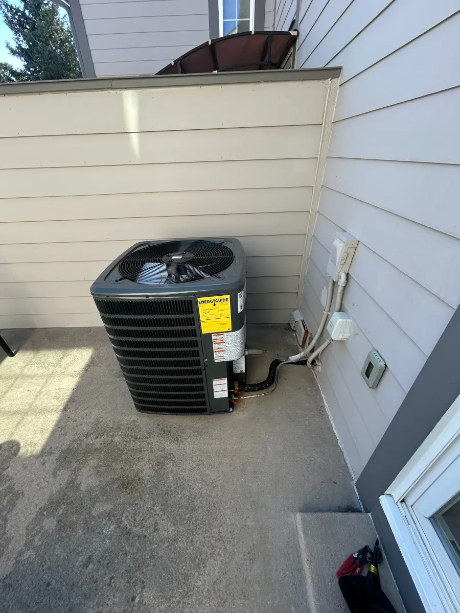 Goodman outdoor unit with EnergyGuide efficiency label at a local Front Range home