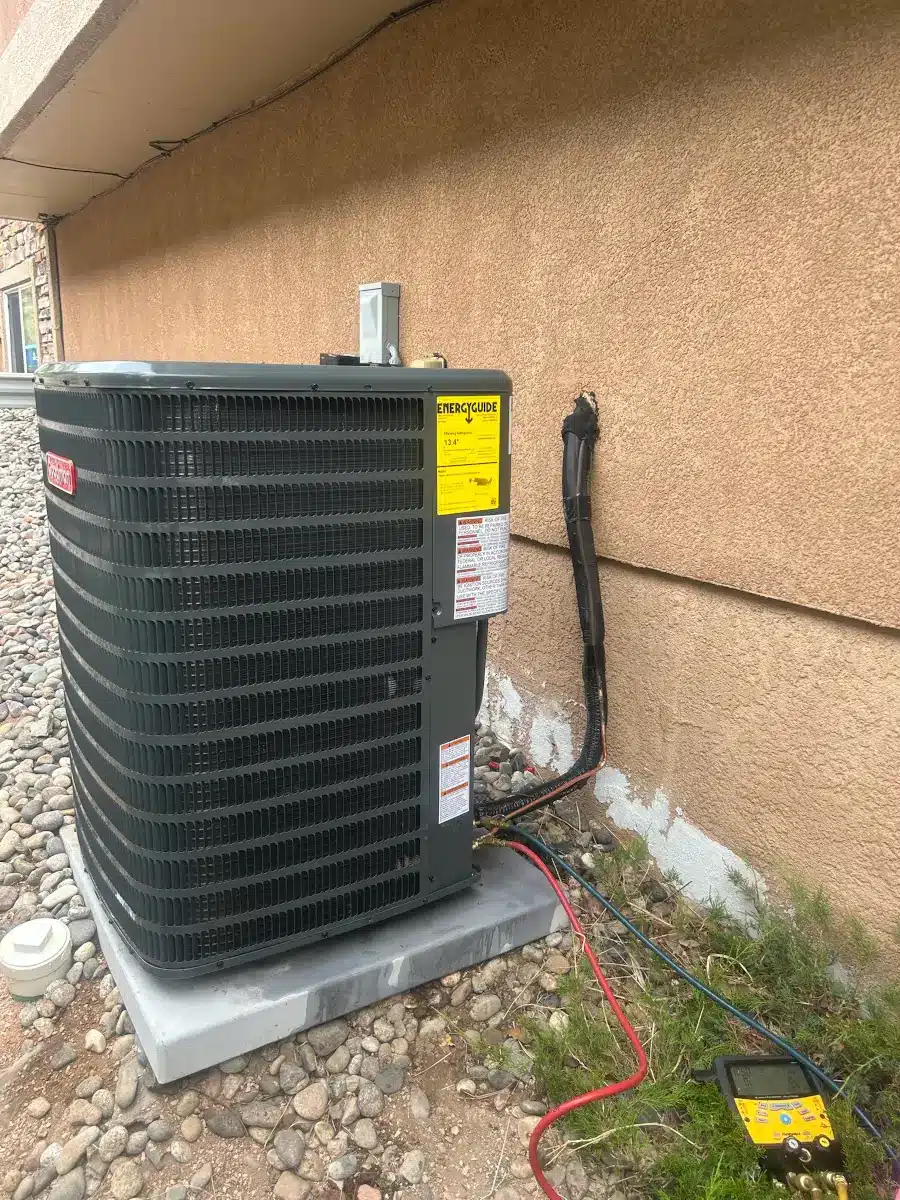 Heat pump rebates qualifying installation in Colorado Springs with technician verifying refrigerant charge